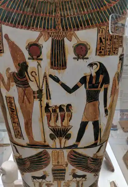 Ancient Egyptian painted coffin showing lower register with winged goddesses and black bulls